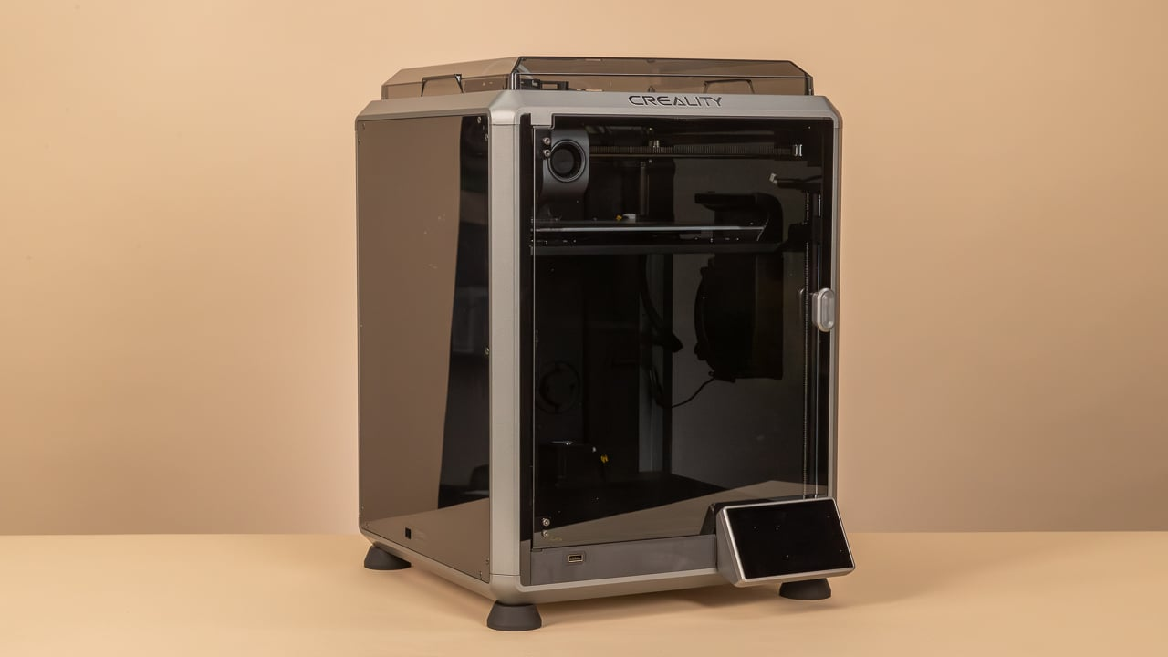 Creality K1 enclosed 3D printer on a warm beige background